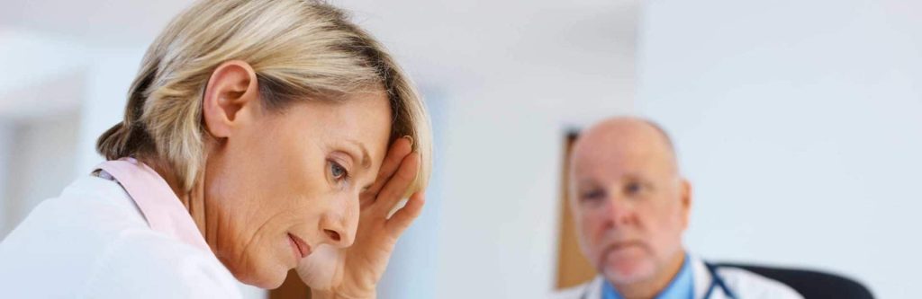 woman at doctor office receiving bad news