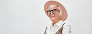 elderly woman with glasses and hat