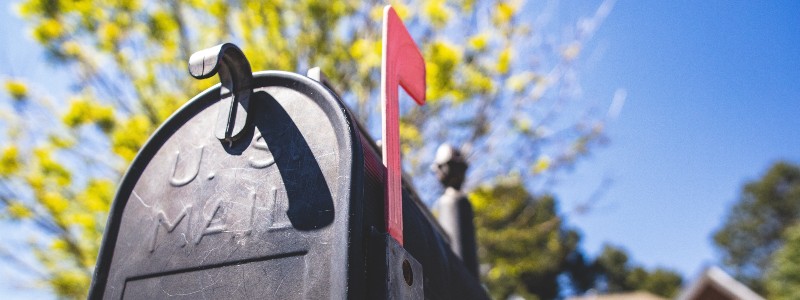 black metal mailbox with raised flag