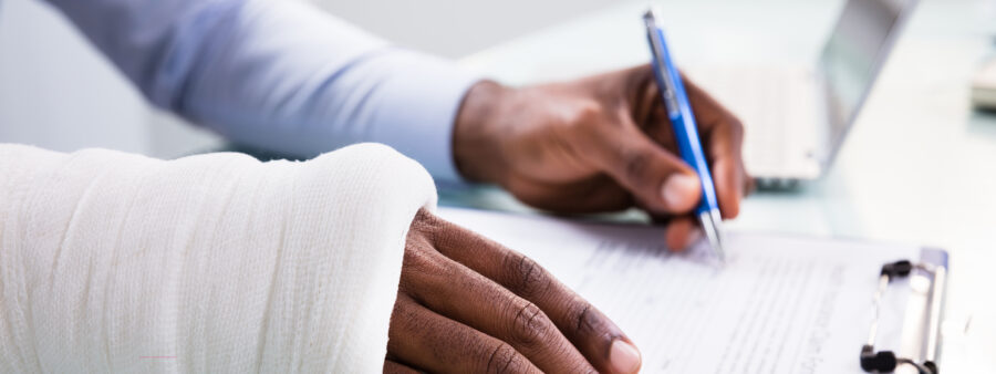 Man filing a workers' comp claim, the benefits from which may not be enough to cover all the costs of an on-the-job car or truck accident in Indiana