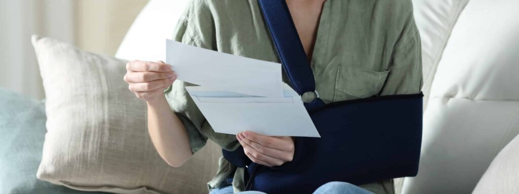 Injured driver reading a denial letter from an insurance company acting in bad faith after an Indiana car accident