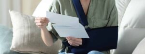 Injured driver reading a denial letter from an insurance company acting in bad faith after an Indiana car accident