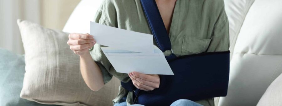 Injured driver reading a denial letter from an insurance company acting in bad faith after an Indiana car accident