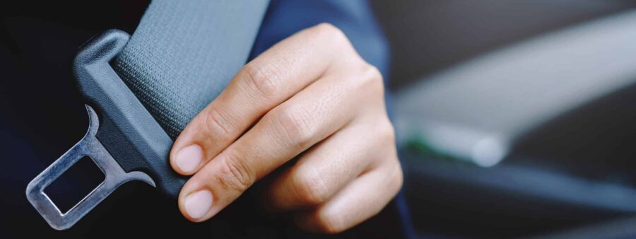 Driver buckling seatbelt, something that fewer drivers are doing in Indiana to the detriment of their car accident injury claims